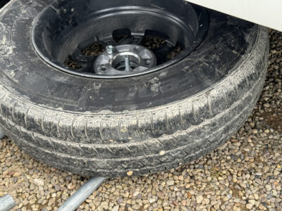 putting damaged wheel tyre on spare wheel carrier (4)